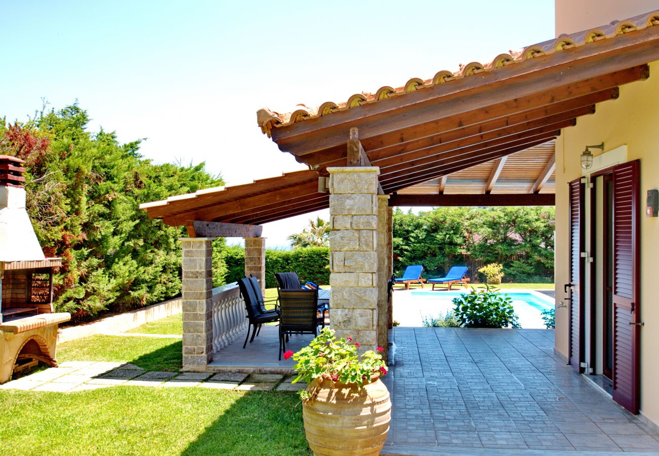 Covered terrace for outdoor dining with BBQ nearby