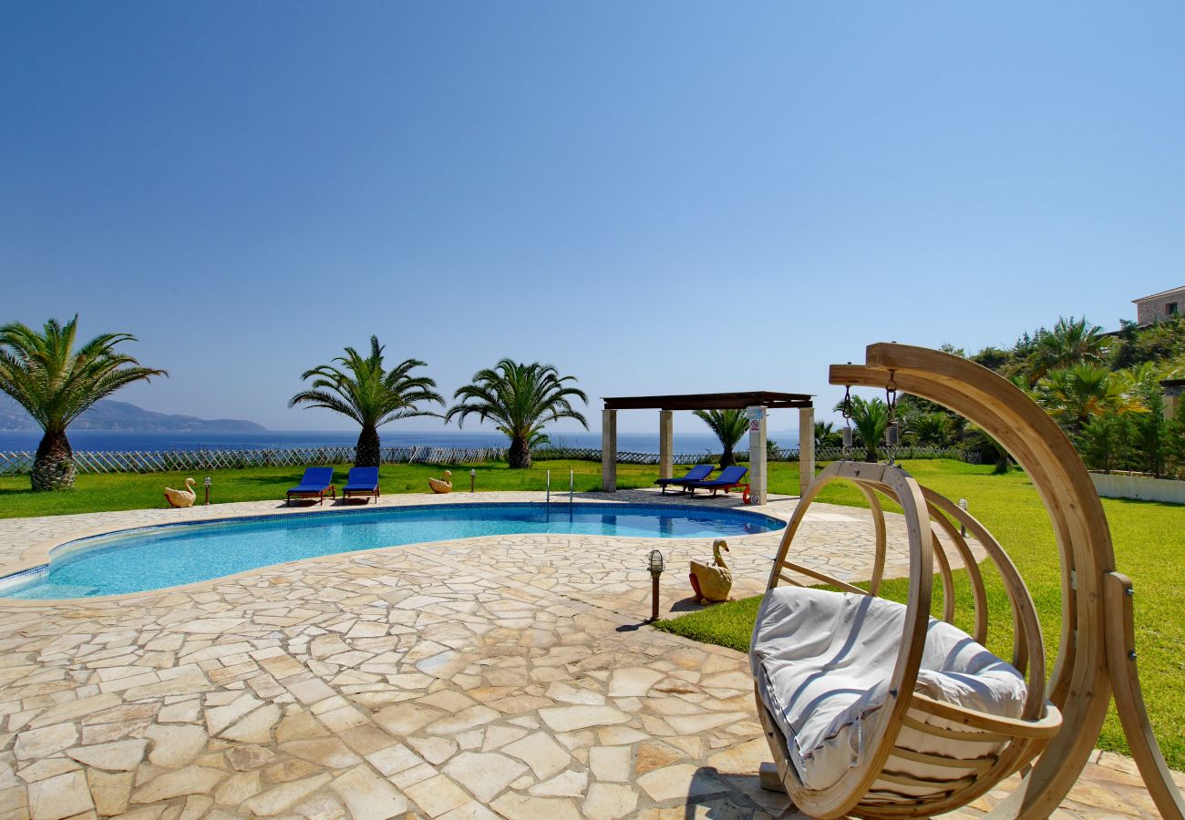 Outdoor wooden swing in the garden of Villa Alexandros