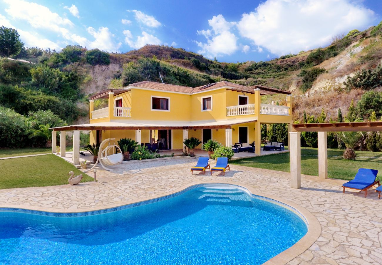 View of Villa Alexandros, the pool and sun terraces, and the hills behind